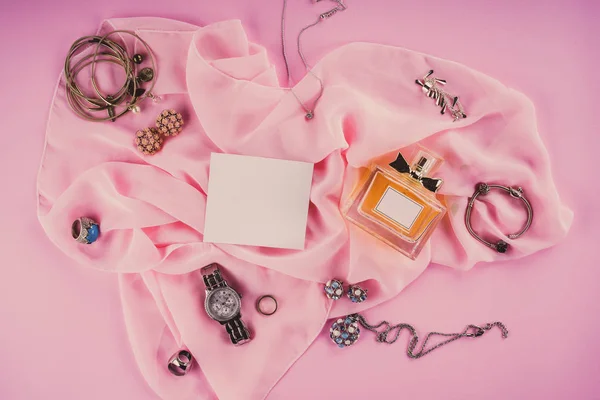 Various makeup products on pink background