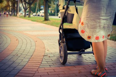 bir yürüyüşte bir bebek arabası ile anne