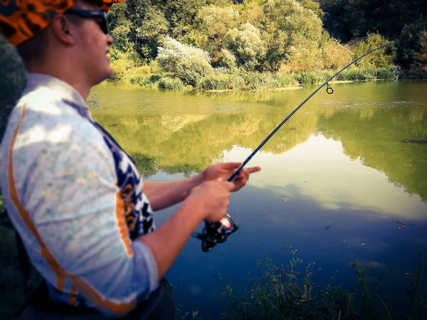 O pescador está pescando no lago no verão — Fotografia de Stock