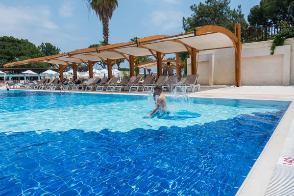 Boy jumping into the pool