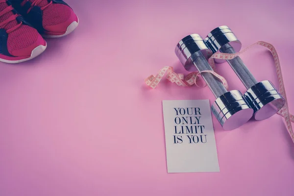 Centimeter, dumbbells on a pink background — Stock Photo, Image