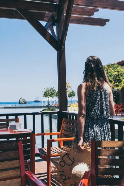 Woman tourist at summer area in resort restaurant