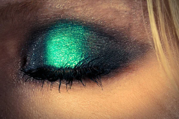 Eye makeup with green shadows