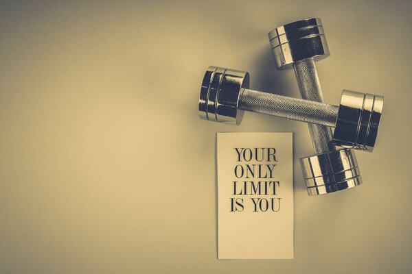 sports concept: dumbbells on a pink background