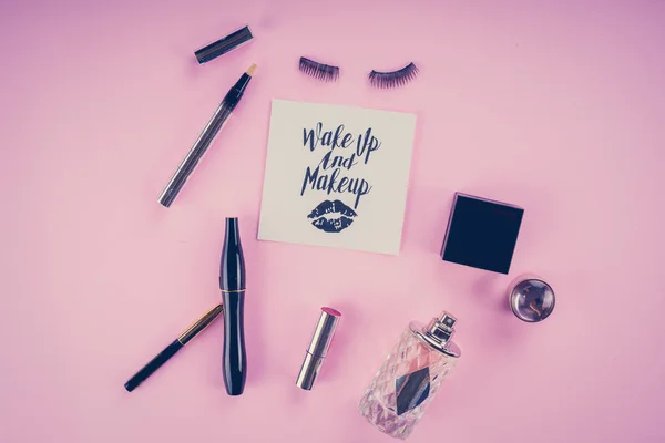makeup tools on a pink background
