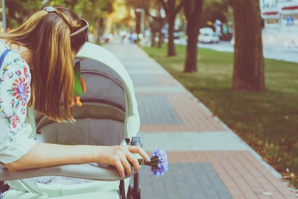 Mother over a stroller — Stock Photo, Image