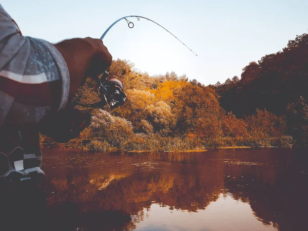 Young man fishing. bokeh , blurred background