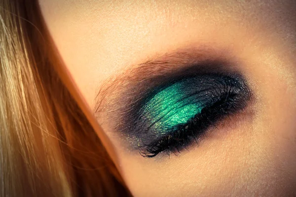 Eye makeup with green shadows