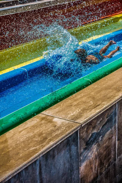 The boy rides a slide in the water park — Stock Photo, Image