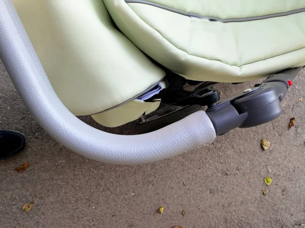 Handle from a pram and legs — Stock Photo, Image