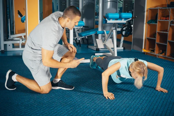 Coach leert het meisje push-up — Stockfoto