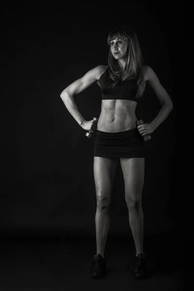 girl bodybuilder with dumbbells black and white
