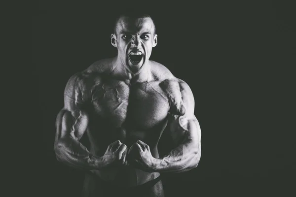 Bodybuilder on black background — Stock Photo, Image