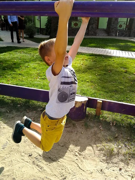 The boy is playing at the playground — Stock Photo, Image