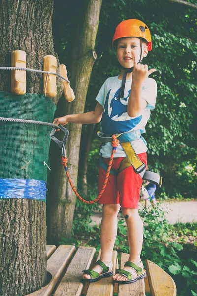 The boy climbs a pendant park — Stock Photo, Image