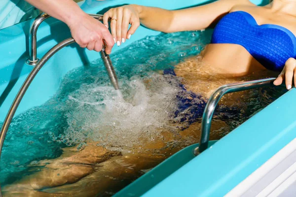 Underwater massage procedure at spa