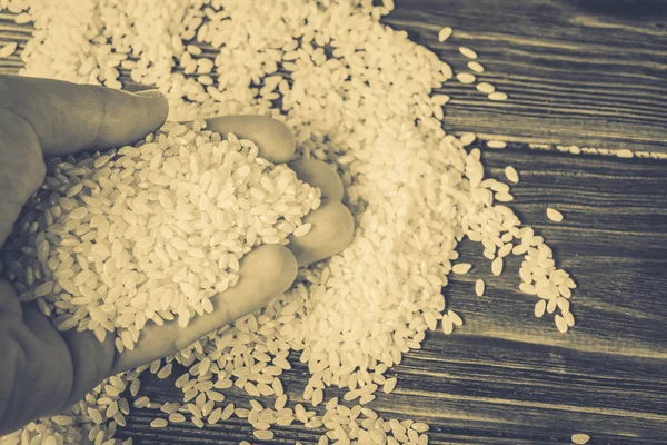 Rice on a wooden table — Stock Photo, Image