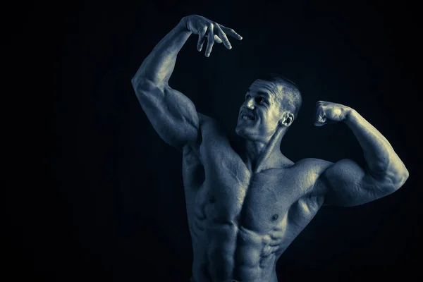 Bodybuilder on black — Stock Photo, Image