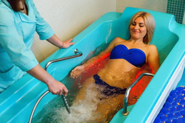 Underwater massage procedure at spa