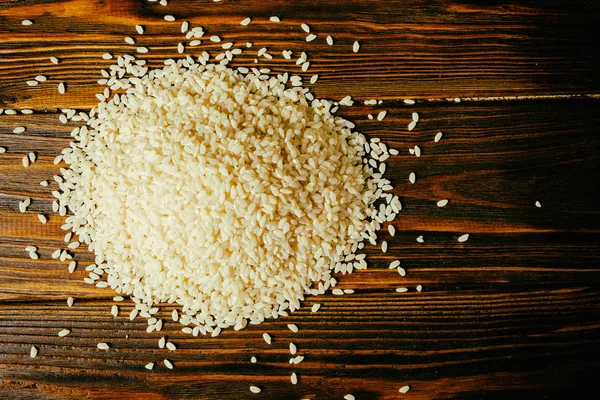 Rice on a wooden background — Stock Photo, Image