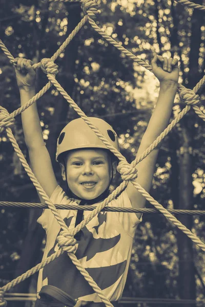 Ten chlapec šplhá lanový park — Stock fotografie