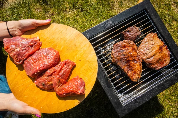 Grill steaks, camping. Portable grill