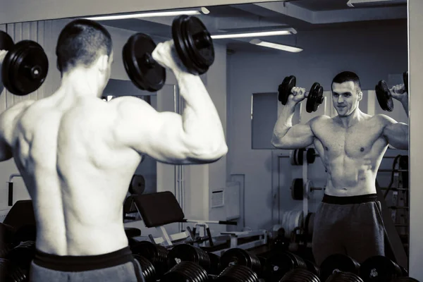 A man trains in the gym, fitness, sport, health