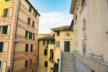 Historic Italian architecture with ornate facades, narrow alley and stone staircase in old town.