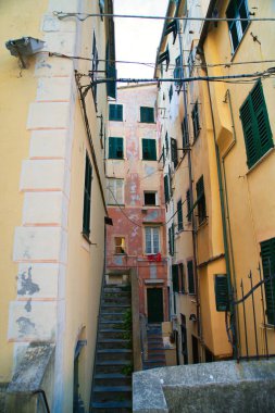 Historic Italian architecture with ornate facades, narrow alley and stone staircase in old town.