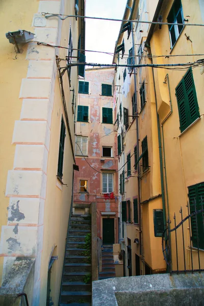 Historic Italian architecture with ornate facades, narrow alley and stone staircase in old town.