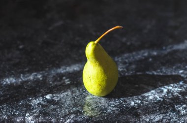 One pear casting a shadow