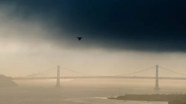 drone take off over golden gate bridge fly to bay bridge San Francisco CA USA