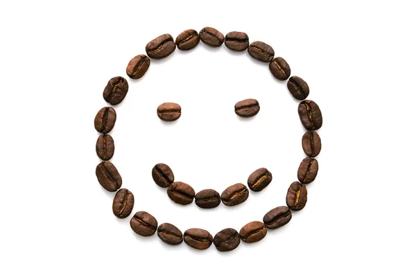 Bild eines lustigen Smileys aus einer Vielzahl von Kaffeebohnen lizenzfreie Stockfotos