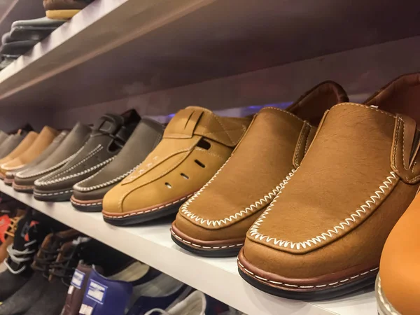 Brown men shoes in a shoes shop.