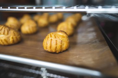 Choux 'un pişirdiği ev, taze çıtır ekler ve profiteroller yapmış. Endüstriyel ölçekte tatlı ve tatlı yapmak, endüstri, arka plan. Choux geleneksel bir Fransız tatlısıdır..