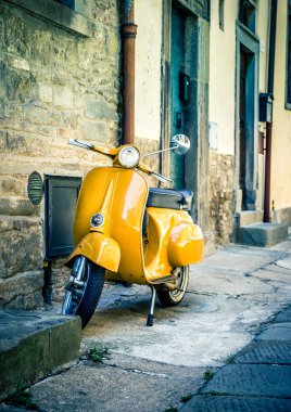 Cortona, İtalya - 26 Haziran 2015: Antika Toskana Cortona şehirdeki sarı scooter. Tipik İtalyan pitoresk sahne.