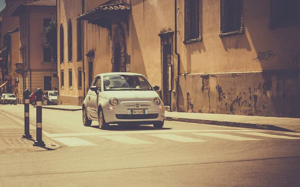 AREZZO, ITALY - JUNE 26, 2015: The newest version of Fiat 500, one of the most popular small city cars in Italy, on cross roads in tuscan Arezzo city, Italy