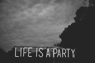 neon sign that says: Life is a party. clipart