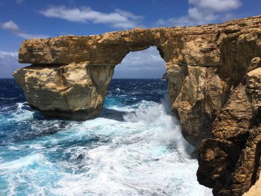 Gozo Malta adasında Akdeniz'de kireçtaşı kaya doğal kemer şeklinde Masmavi pencere.