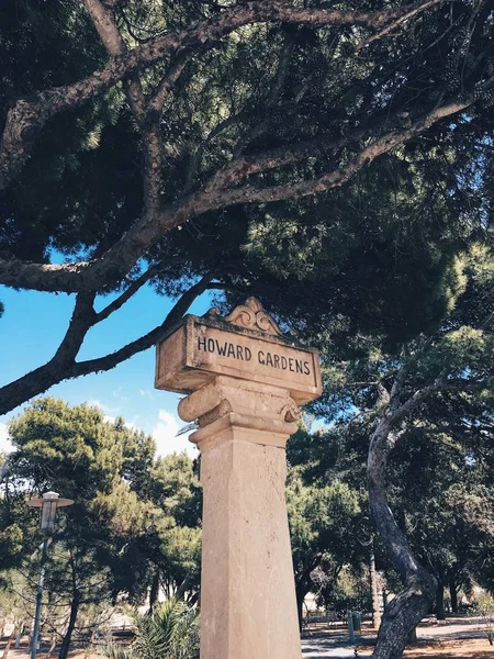 Weathered stone sign post in Howard Gardens, Rabat, Mdina, Malta.