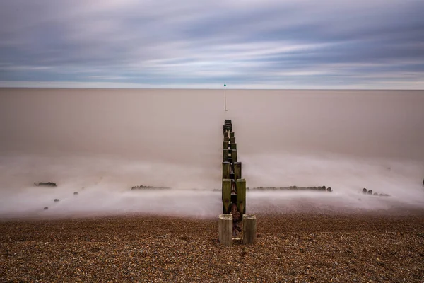 Minimalistic long exposure looking out to sea at Bawdsey, Suffolk, UK. Frame contains a lot of empty space — Stock Photo, Image