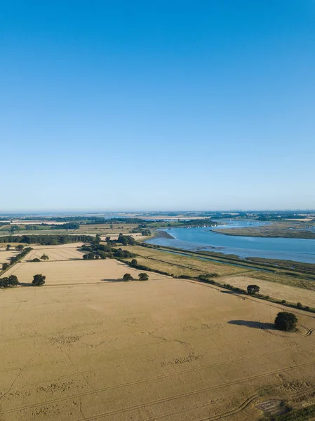 An aerial view of a farm field with the river Deben flowing in the background — Stock Photo, Image
