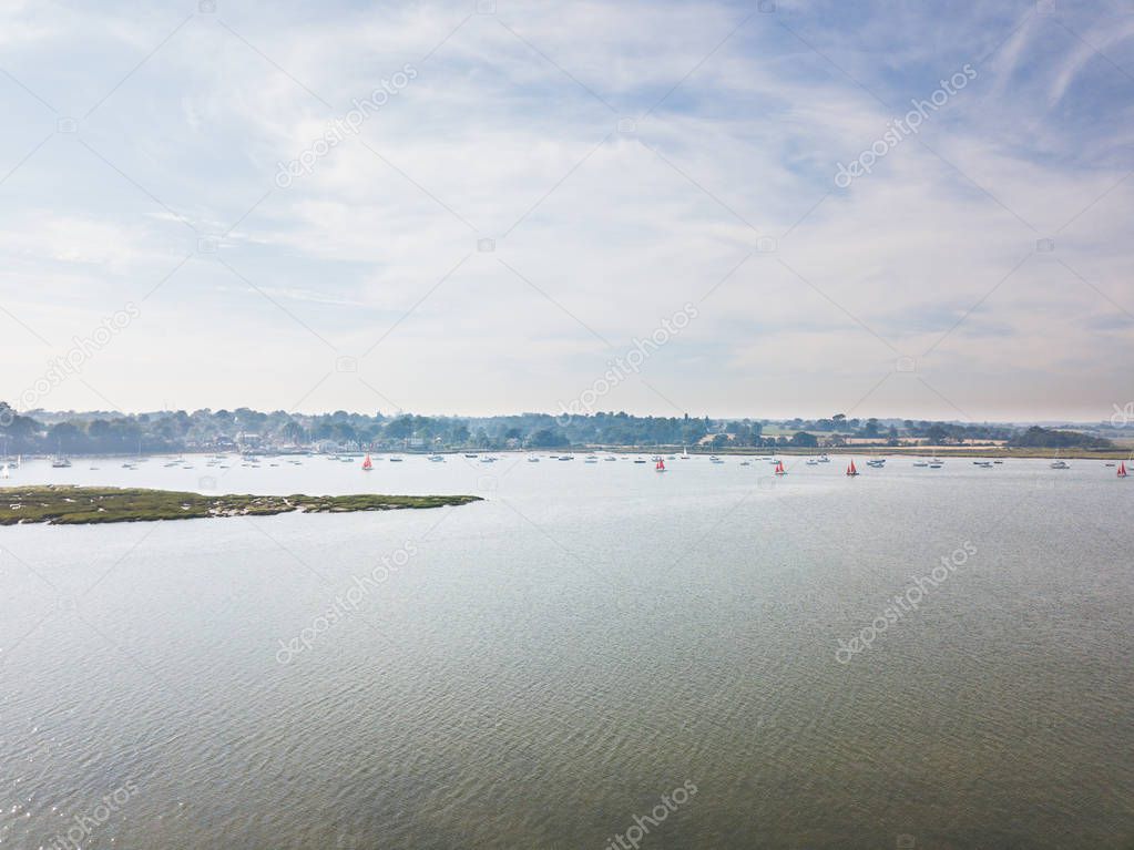 Aerial view of the River Deben with a selection of different sailing boats enjoying the summers day