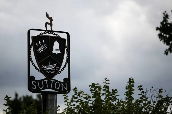 A traditional village sign for the small countryside village of Sutton in Suffolk