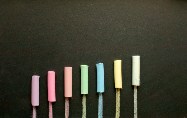 Multicolored chalk on slate — Stock Photo, Image