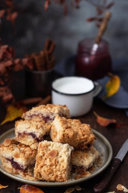 Lezzetli taze turta parçaları ile dolu bir tabak çilek reçeli ve üzeri fındıkla süslenmiş. 