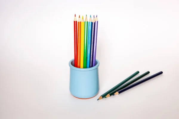 Set of colored pencils in the blue vase on background. — Stock Photo, Image