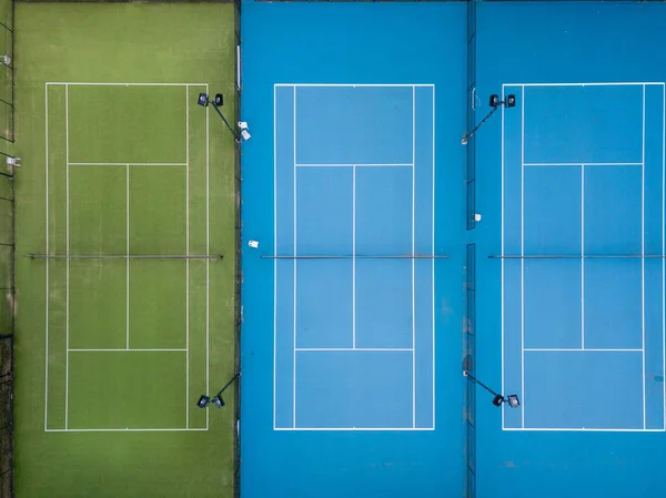 Aerial shot of three tennis courts side by side