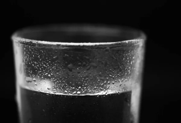 One glass of water in studio with black background — Stock Photo, Image