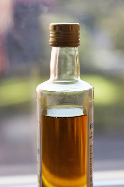 A bottle of the finest organic olive oil standing in the window Stock Photo